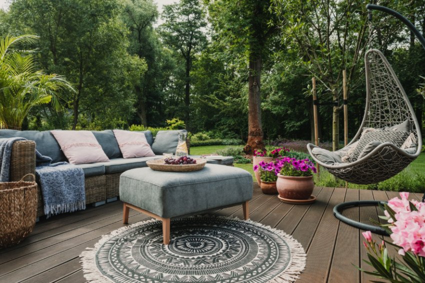 Designer reviewing outdoor living plans for a lakeside Milledgeville, GA property with detailed site sketches and samples