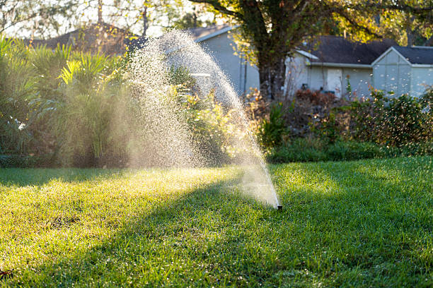 Irrigation in Perry, GA being adjusted as a technician tests sprinkler reach along garden beds
